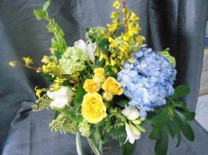 Yellow roses, blue hydrangea $45